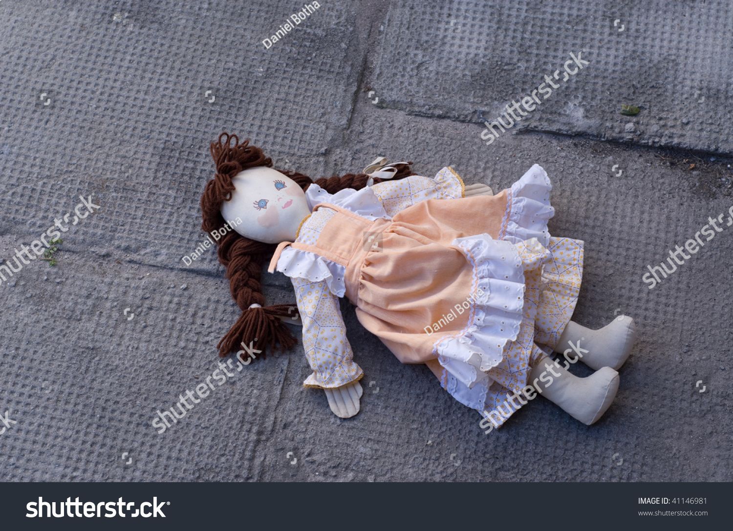 stock-photo-abandoned-rag-doll-left-in-the-dirt-41146981.jpg