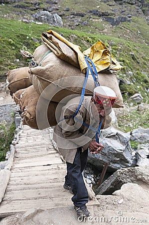 manali-india-september-old-man-carrying-bags-sheeps-wool-crossing-bridge-september-th-manali-ind-65693818.jpg