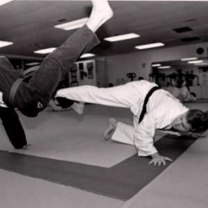 Low spinning sweep against a high spinning kick. Photo was taken by Tom Pennington, UTA Shorthorn photographer, in 1995 for a story.