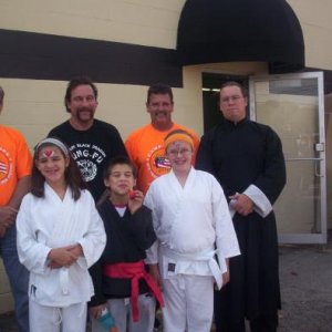 Representatives from Camp Hope, Master Ike Bear, Jason Cook, and some of the kids class