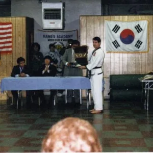 My sah bum nim, Master Hannah reciving his 5th dan certificate, and a plaque for becoming the first sah bum nim under Kwan Jang Sok Ho Kang, in the pi