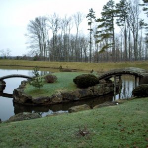 Close image of two arc bridges connecting 2 of the three islands on the pond. Sadly, there is no access to the islands.