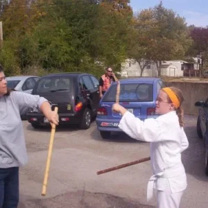 Jeanne Hardesty demonstrating stick work with one of the kids