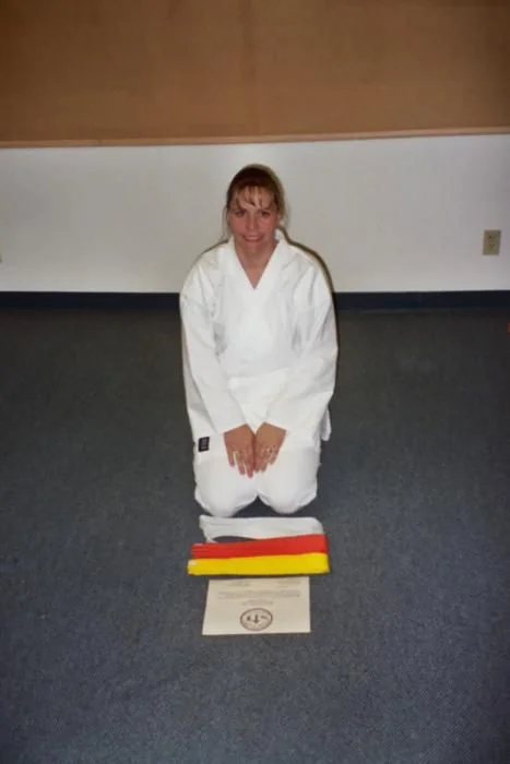 Christie recieving her Orange Belt, many moons ago!