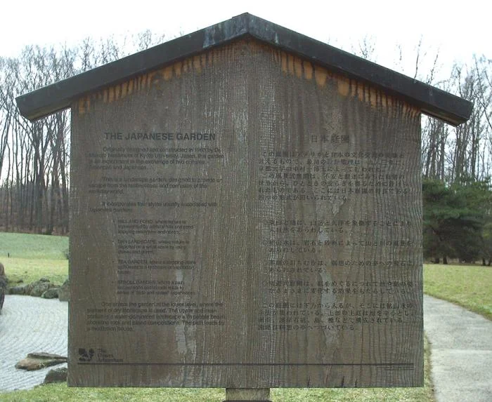 English/Japanese wooden sign describing the garden