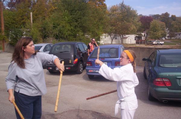 Jeanne Hardesty demonstrating stick work with one of the kids
