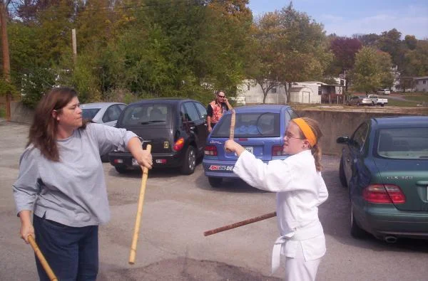 Jeanne Hardesty demonstrating stick work with one of the kids