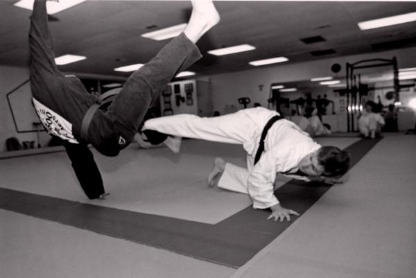 Low spinning sweep against a high spinning kick. Photo was taken by Tom Pennington, UTA Shorthorn photographer, in 1995 for a story.