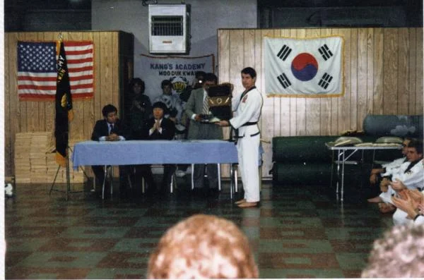 My sah bum nim, Master Hannah reciving his 5th dan certificate, and a plaque for becoming the first sah bum nim under Kwan Jang Sok Ho Kang, in the pi