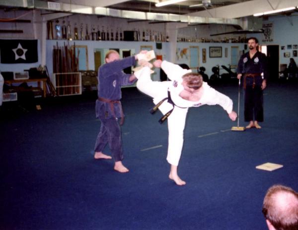 Robert McLain breaking two boards with a hapkido spinning kick around 1999. Holder is Eric Fleming from the Tuscon, Arizona Chayon-Ryu dojang.