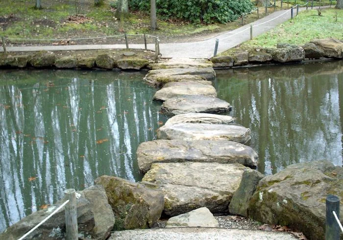 Stones bridging a narrow section of the pond