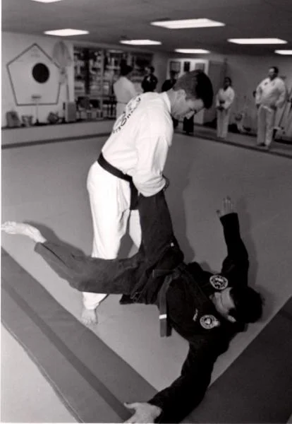 Take down against a front kick attack. Photo was taken by Tom Pennington, UTA Shorthorn photographer, in 1995 for a story.